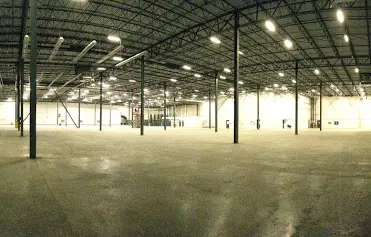 empty warehouse - showing the warehouse floor, columns, trusses and roof