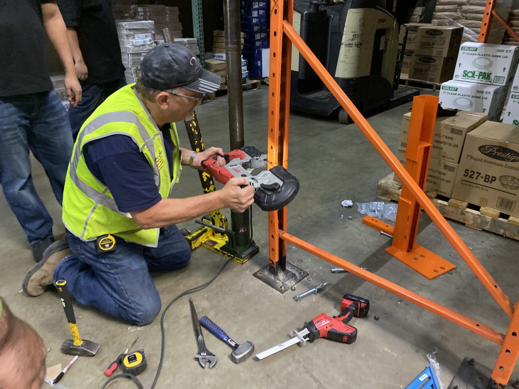 Rack installers cutting rack in order to repair pallet racking